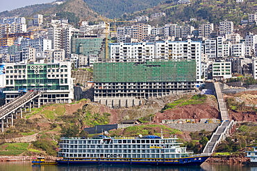 Victoria Line cruise ship by new town built to re-home communities as part of Three Gorges dam project, China