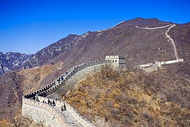 The ancient Great Wall of China snaking through mountains at Mutianyu, north of Beijing (formerly Peking)