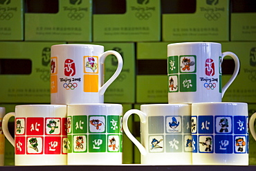 2008 Olympic Games official souvenirs Fuwa mascot characters souvenir mugs on sale in Beijing shop, China