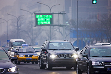 Imported BMW X5 4 wheel drive vehicle in traffic on Beijing main street, China