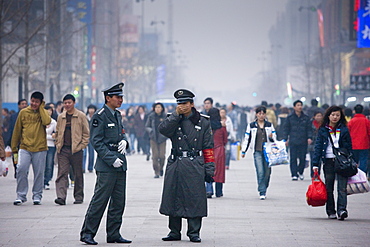 Chinese policemen on Wangfujing street of Central Beijing, China