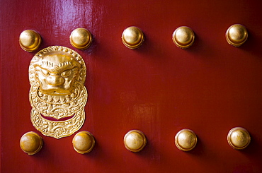 Nails and lion-head knocker on gate to Tower of Buddhist Incense at The Summer Palace, Beijing, China