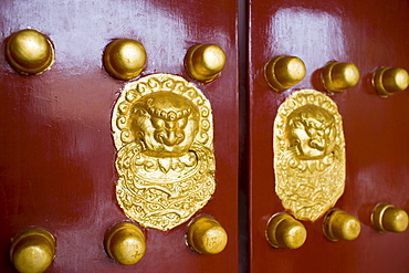 Nails and lion-head knockers on gate to Tower of Buddhist Incense at The Summer Palace, Beijing, China