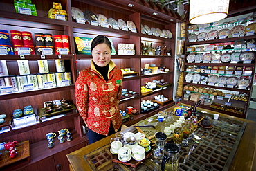 Woman working in tea shop near the Yu Garden Bazaar Market, Shanghai, China