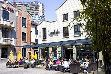 Diners eating outside the Fountain Bistro in redeveloped Xintiandi, Huang Pi Road, Shanghai, China