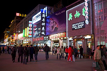 Crowded pavement and shops of Wangfujing Street, Beijing, China