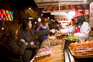 Stall selling meat kebabs in the Night Market, Wangfujing Street, Beijing, China