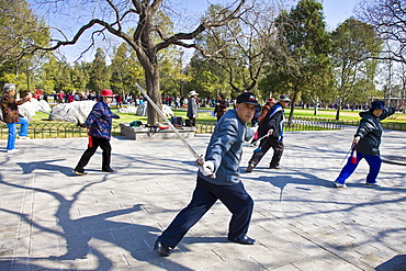 Tai chi with swords in park of the Temple of Heaven, Beijing, China