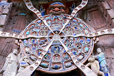 Anicca, God of Destiny holds wheel of life of Buddhist Karma, Dazu rock carvings, Mount Baoding, China