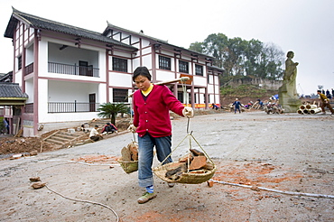 Woman at work building new tourist centre at Dazu Rock Carvings, Mount Baoding, Chongqing, China