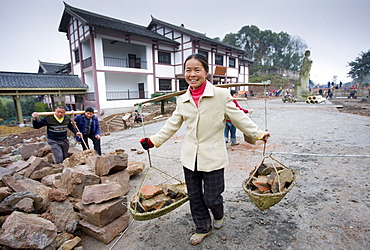 Woman at work building new tourist centre at Dazu Rock Carvings, Mount Baoding, Chongqing, China