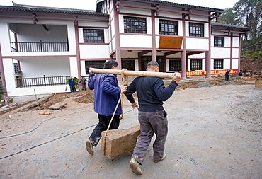 Men at work building new tourist centre at Dazu Rock Carvings, Mount Baoding, Chongqing, China