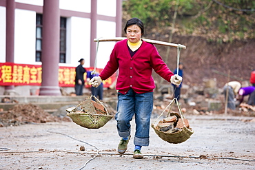 Woman at work building new tourist centre at Dazu Rock Carvings, Mount Baoding, Chongqing, China