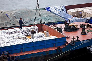 Aluminim ingot blocks being loaded onto cargo ship, Yichang, China