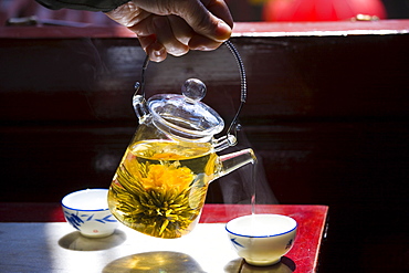 Flower infused tea being poured in the Huxinting Teahouse, Yu Garden Bazaar Market, Shanghai, China