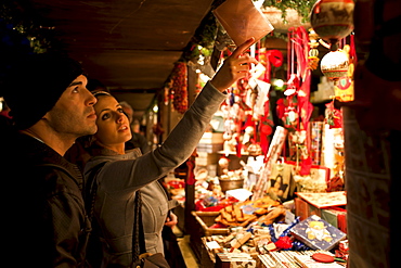 Customers shopping for Christmas ornaments at Christmas market, Winter Wonderland, in Hyde Park, London