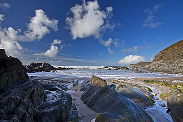 Waves lapping onto the beach at Watersmeet Bay near Woolacombe, North Devon, UK