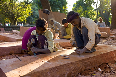 Stonemasons using traditional manual skills at stone workshop at Humayuns Tomb,  in New Delhi, India