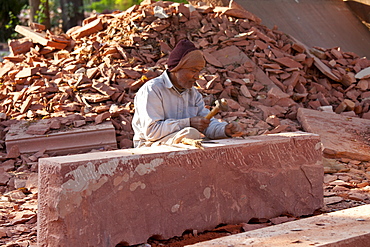 Stonemason using traditional manual skills at stone workshop at Humayuns Tomb,  in New Delhi, India