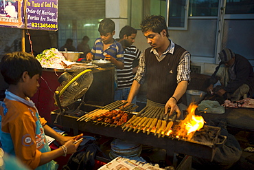 Food, meat kebabs, on sale at meat stall in Snack market at muslim Meena Bazar, in Old Delhi, India