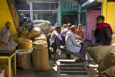 Indian Hindu porters with sacks of spices and dried foods at Khari Baoli Spice and Dried Foods Market in Old Delhi, India