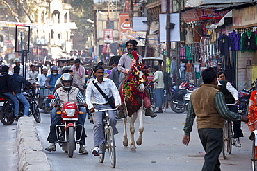 Busy street scene in holy city of Varanasi, Benares, Northern India