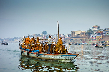 Buddhist monks in boat cruise on River Ganges at Varanasi, Benares, Northern India