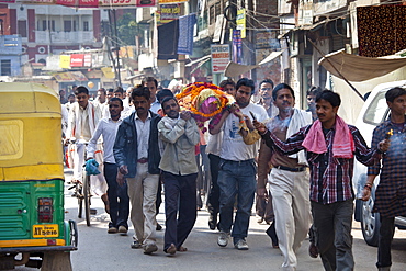 Body of dead Hindu woman carried in procession in street for funeral pyre cremation by the Ganges, Varanasi, Benares, Northern India