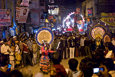 Costume characters with flaming torches in crowd at Festival of Shivaratri in the holy city of Varanasi, Benares, India