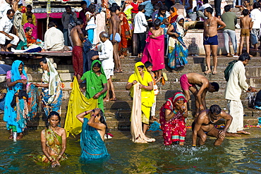 Indian Hindu pilgrims bathing in The Ganges River at Dashashwamedh Ghat in Holy City of Varanasi, Benares, India