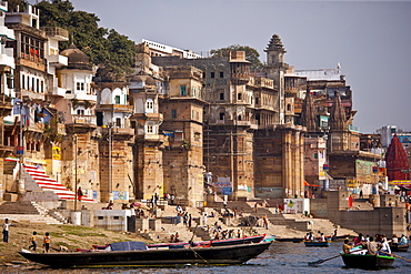 Tourists in boats at Ranamahal Ghat and Chousatti Ghat watch traditional bathing in Varanasi, India