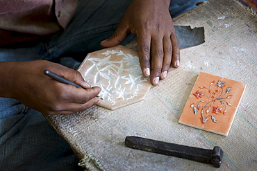 Skilled craftsman at work making Pietra Dura gem souvenirs using traditional old-fashioned methods in Agra, India