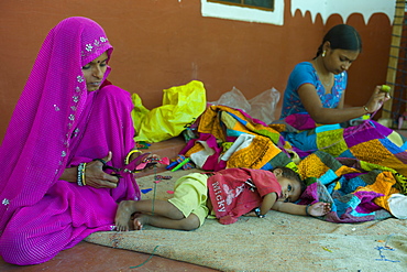 Indian women sewing textiles at Dastkar women's craft co-operative, the Ranthambore Artisan Project, in Rajasthan, Northern India