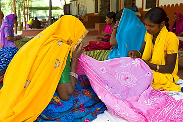 Indian women sewing textiles at Dastkar women's craft co-operative, the Ranthambore Artisan Project, in Rajasthan, Northern India