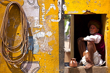 Indian man at his home and business at Ganesh Dham in Sawai Madhopur district in Rajasthan, Northern India