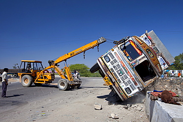 TATA Truck overturned in traffic accident lifted by ACE lifting gear on Delhi to Mumbai National Highway 8 at Jaipur, Rajasthan, India