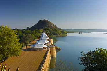 Chhatra Sagar reservoir and luxury tented camp oasis in the desert at Nimaj, Rajasthan, Northern India