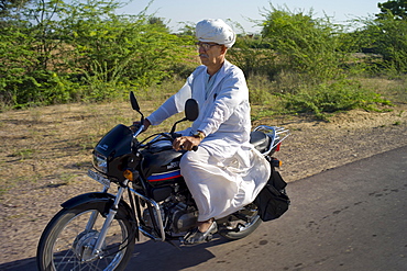 Indian man travelling on motorcycle at Rohet, Rajasthan, Northern India