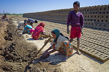 Indian family making bricks made from mud clay at Khore Bricks Factory, Rajasthan, Northern India