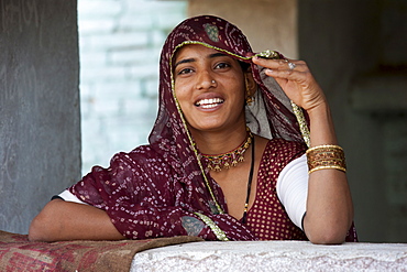 Pretty young Indian woman at home in Narlai village in Rajasthan, Northern India