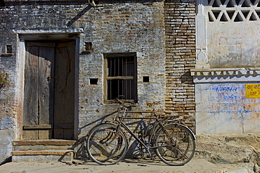 Bicycles propped on old building in Narlai village in Rajasthan, Northern India