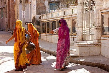 Rajasthani women carrying water pots in the village of Narlai in Rajasthan, Northern India