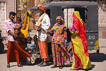 Indian family three generations with pregnant young wife by auto rickshaw in Sadri town in Pali District of Rajasthan, Western India