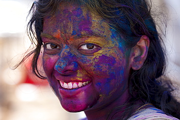 Indian woman celebrating annual Hindu Holi festival of colours with powder paints in Mumbai, formerly Bombay, Maharashtra, India