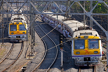 Office workers on crowded commuter train of Western Railway near Mahalaxmi Station on the Mumbai Suburban Railway, India