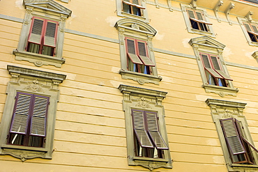 Traditional architecture and window shutters Via Cesare Battisti in Lucca, Italy