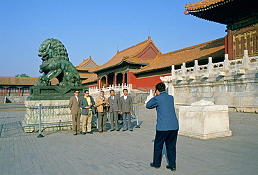 Tourists posing for photographs  in Forbidden City, Beijing, China