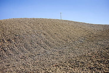 Telegraph pole in barren landscape at Murlo in Tuscany, Italy