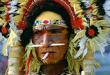 A cigarette between the lips matches the bone through his nose for this man at a Sing Sing tribal gathering in Papua New Guinea