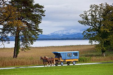 Tourist bus at Konigschloss Herrenchiemsee castle on Herren Insel island in Chiemsee Lake, Baden-Wurttenberg, Bavaria, Germany